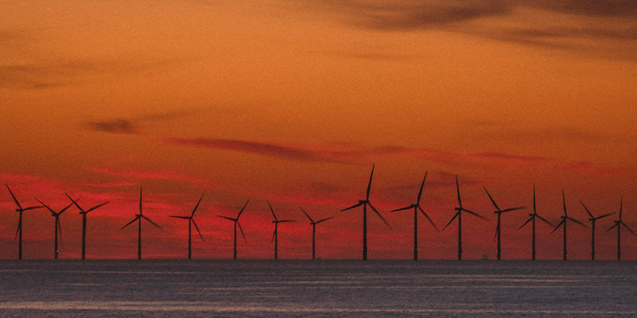 Wind turbines against a sunset background