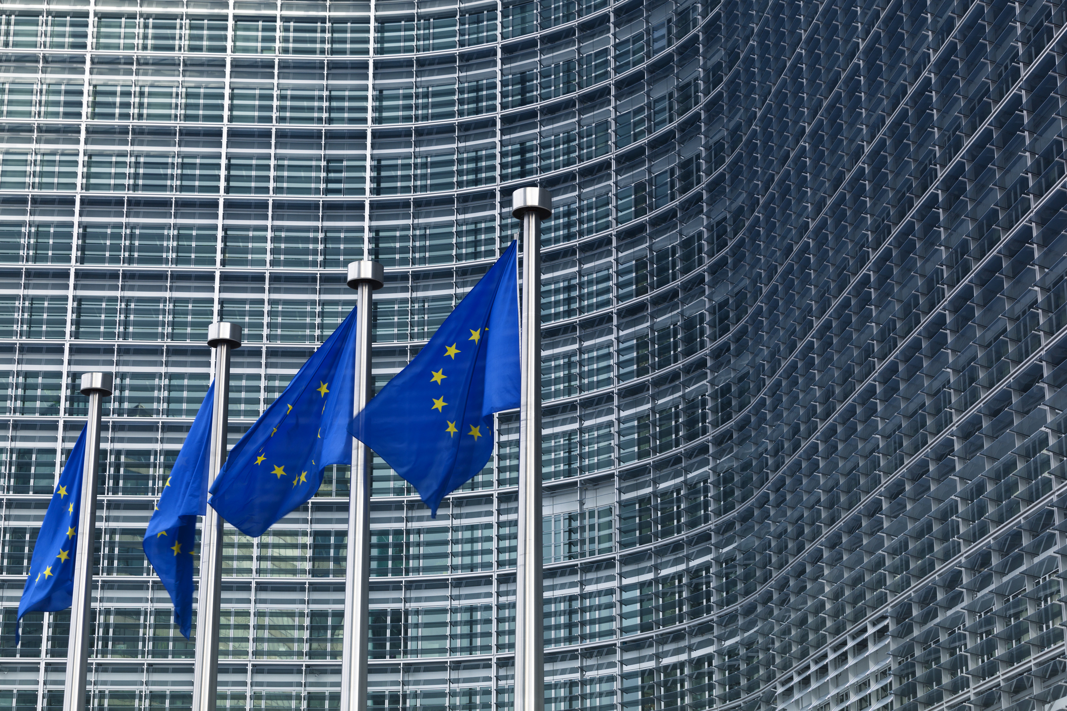 EU flags in front of the European Commission building in Brussels