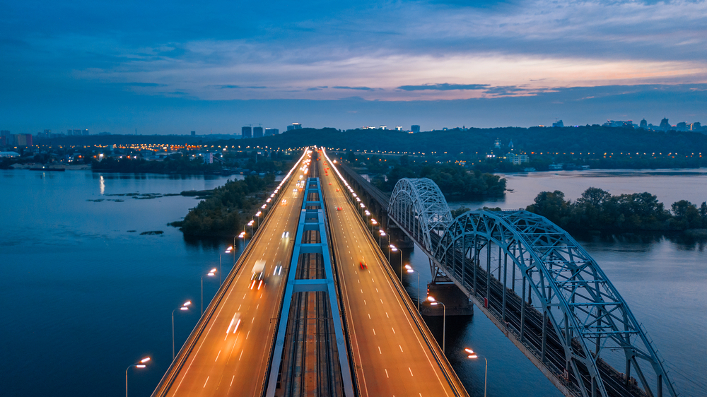 image of a road by a bridge at dusk