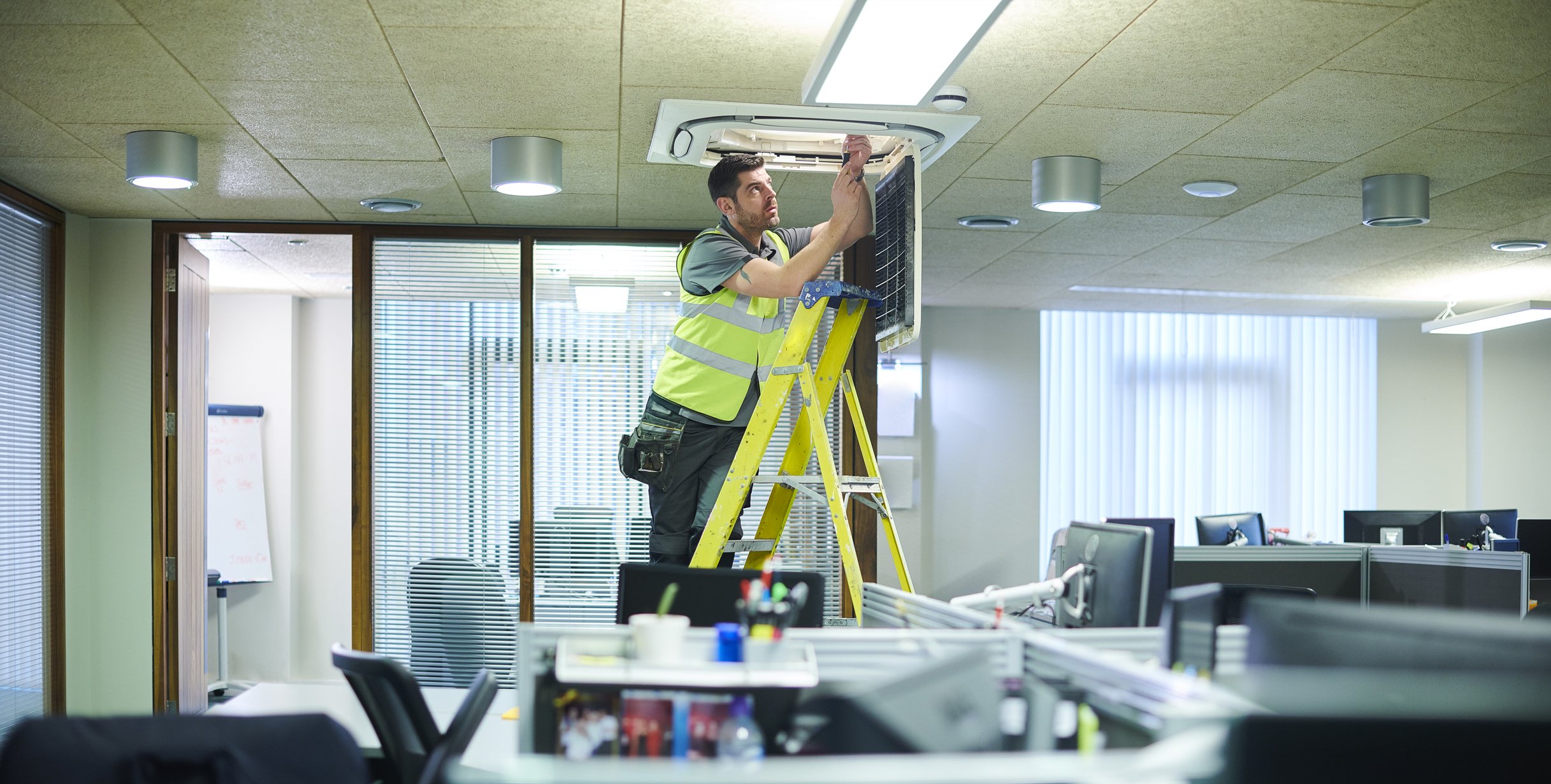 man working on the roof of an office