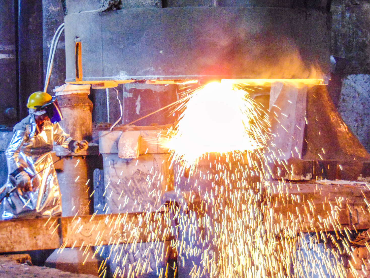 Figure welding metal with huge sparks