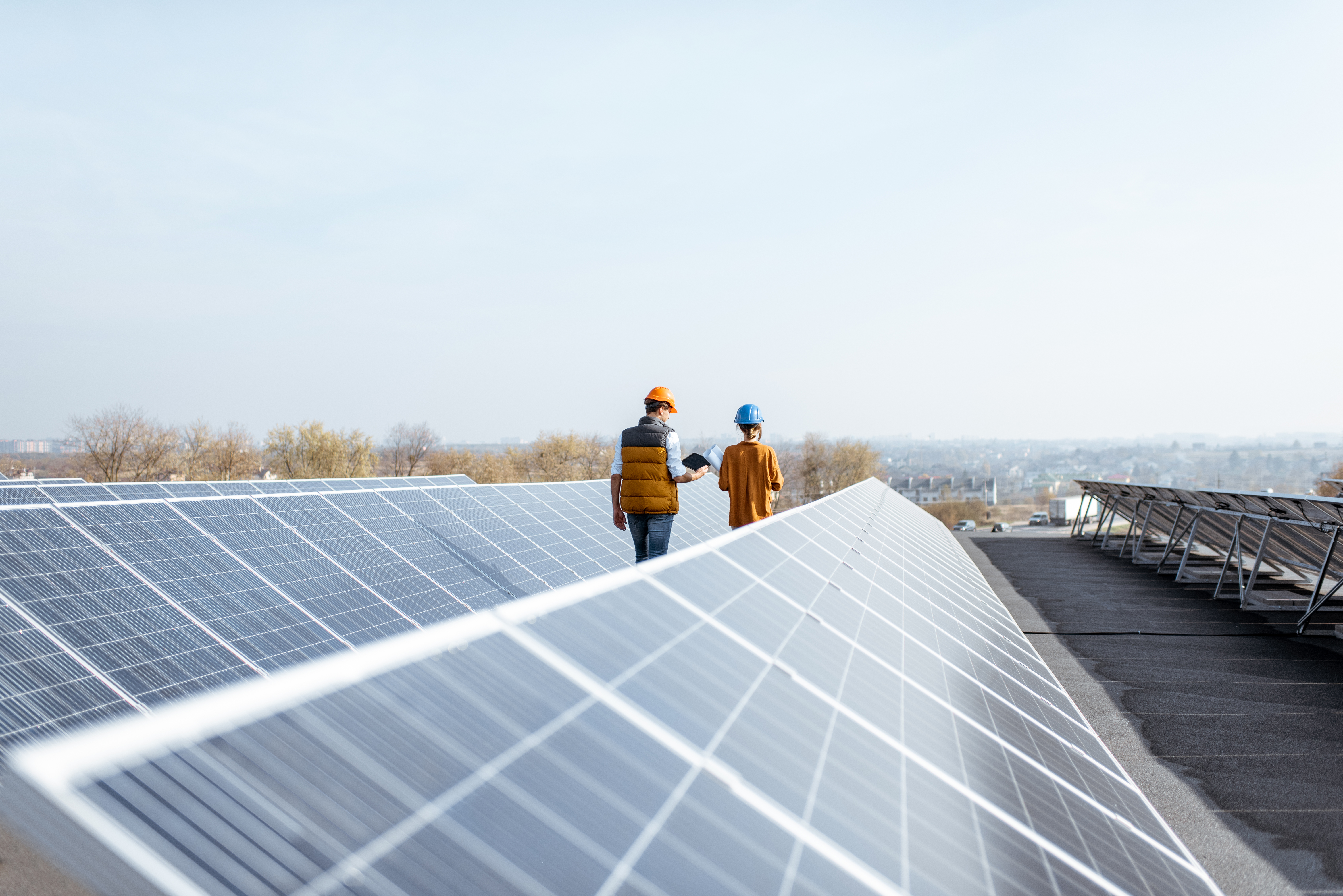 Man and woman inspecting solar panels