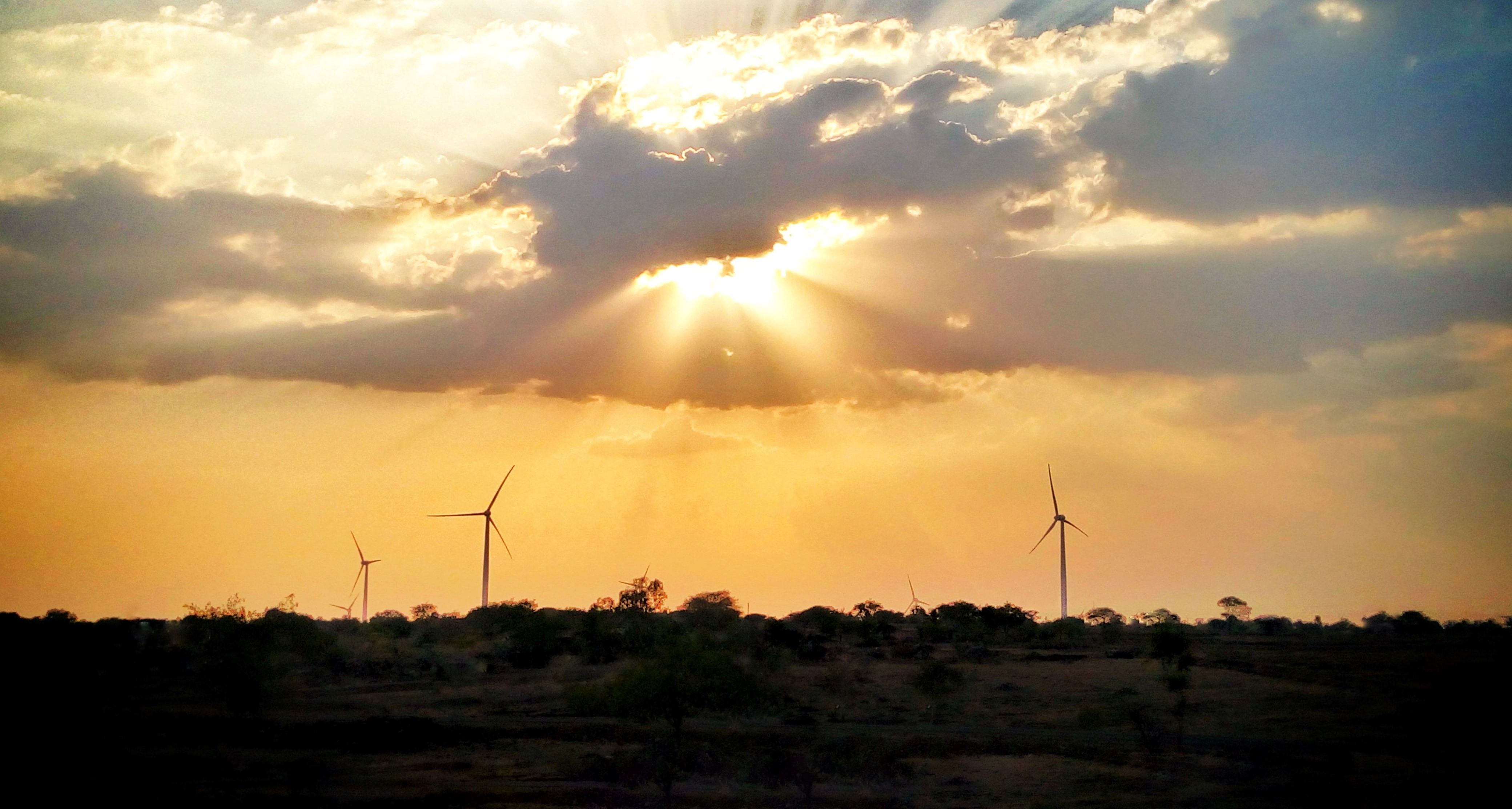 Sun shining on wind turbines