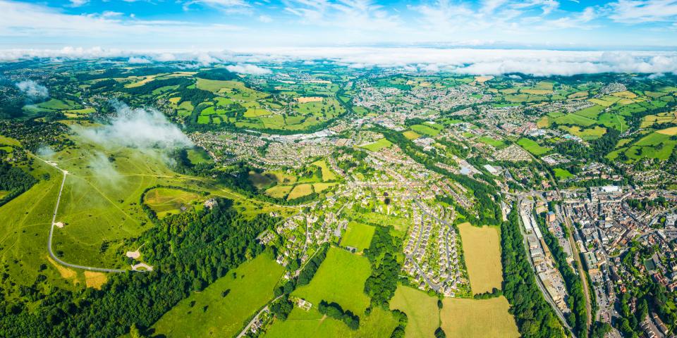 Aerial view of suburban homes and green fields in the UK