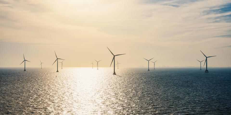 Sun rising on offshore wind farm