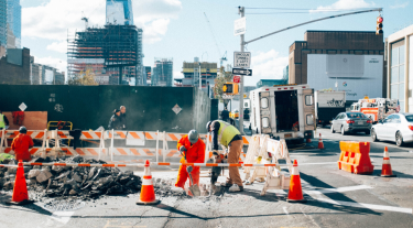Construction workers in a city