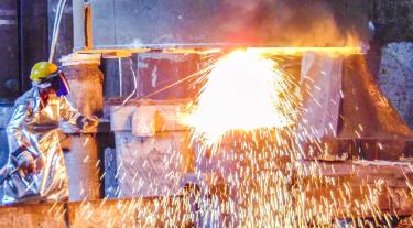 Figure welding metal with huge sparks