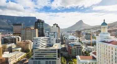 View of South African city with high rise buildings and mountains in the background