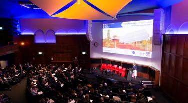 Presentation and audience members at TEA event in London, 2019