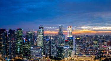 high rise buildings lit up at dusk
