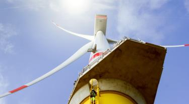 looking up at a wind turbine