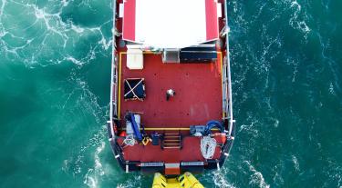 Offshore transfer vessel pushing on wind-turbine