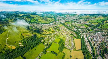 Aerial view of suburban homes and green fields in the UK