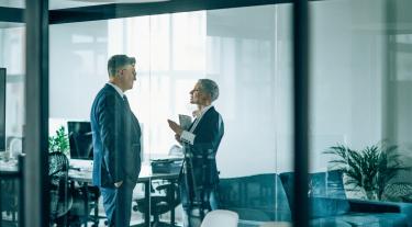 Man and woman talking in an office