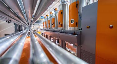 Pipes, tubes, machinery at factory.