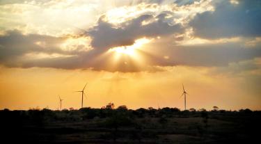 Sun shining on wind turbines