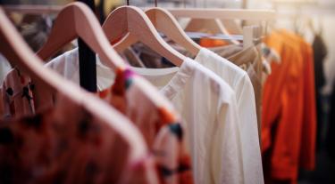 clothes hanging on wooden hangers - white and orange